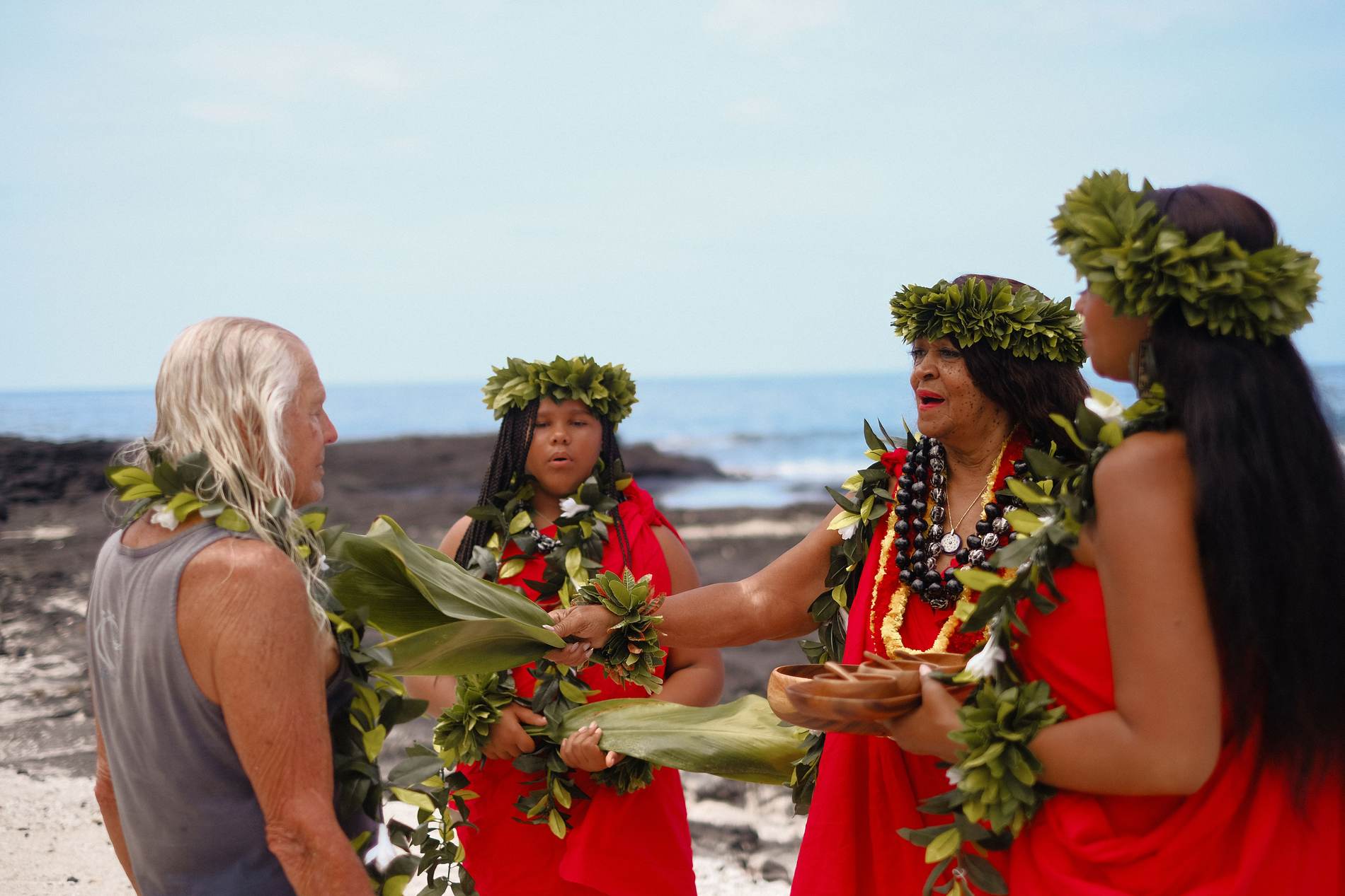 A blessing given with ti leaves on the shore