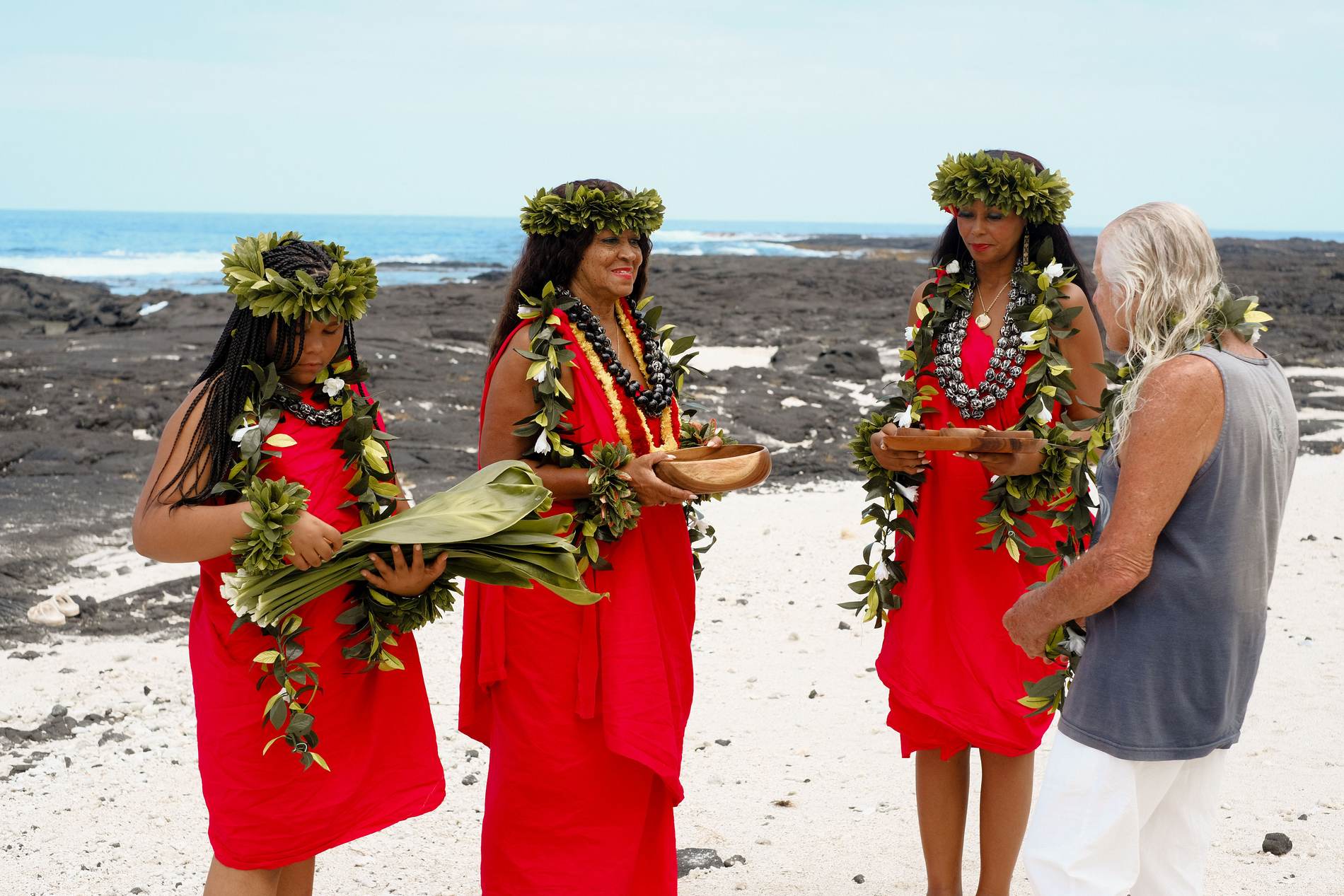 Kahu Kāhealani offering the bowl on the shore