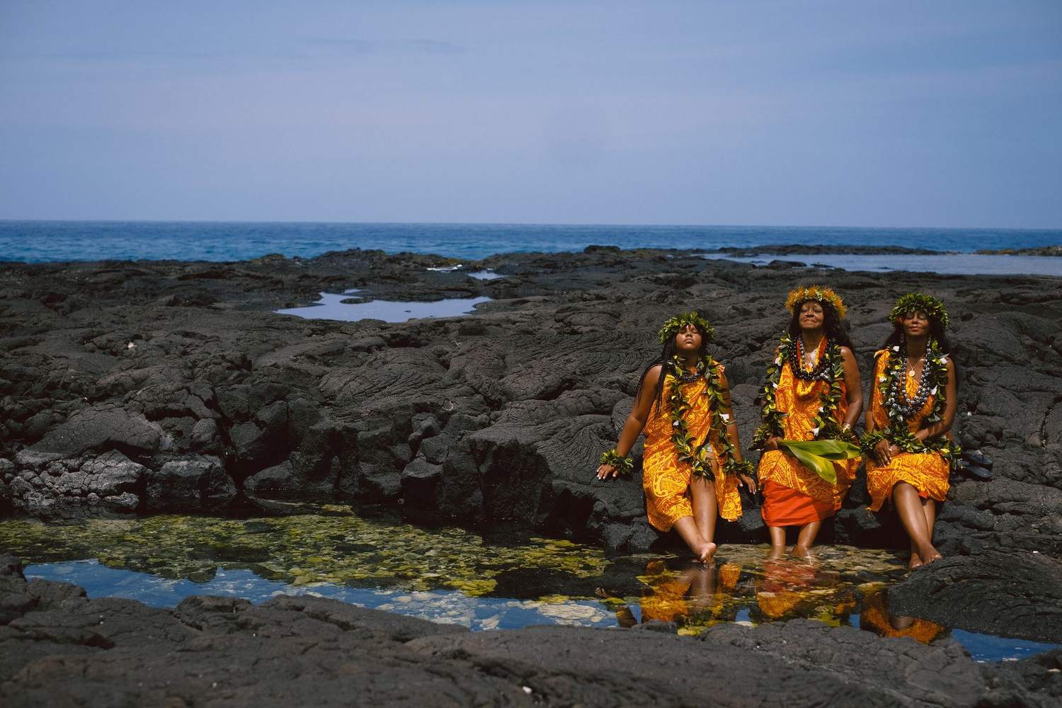 Kahu Kāhealani with her daughter and granddaughter on the lava shore