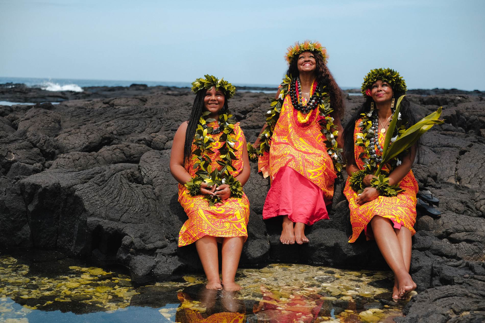Kahu Kāhealani laughing with her daughter and granddaughter on the lava